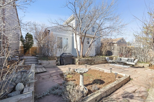 exterior space with grilling area, outdoor lounge area, and fence