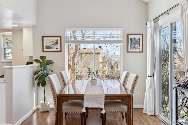 dining area featuring baseboards and wood finished floors