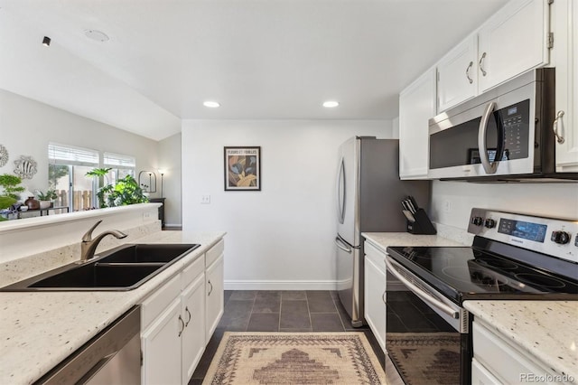 kitchen featuring recessed lighting, white cabinets, appliances with stainless steel finishes, and a sink