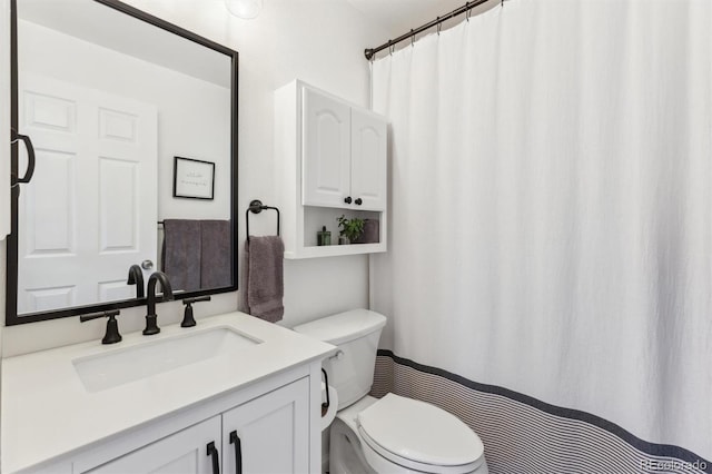 full bathroom with toilet and vanity