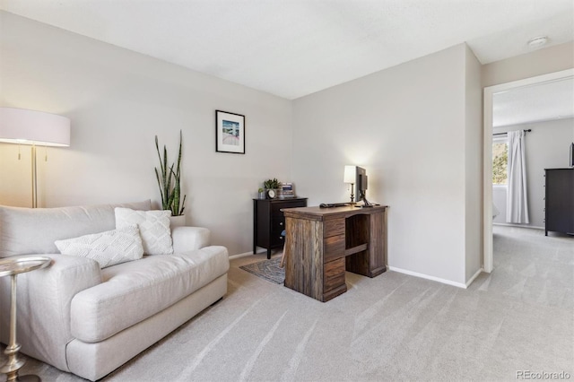 home office featuring light colored carpet and baseboards