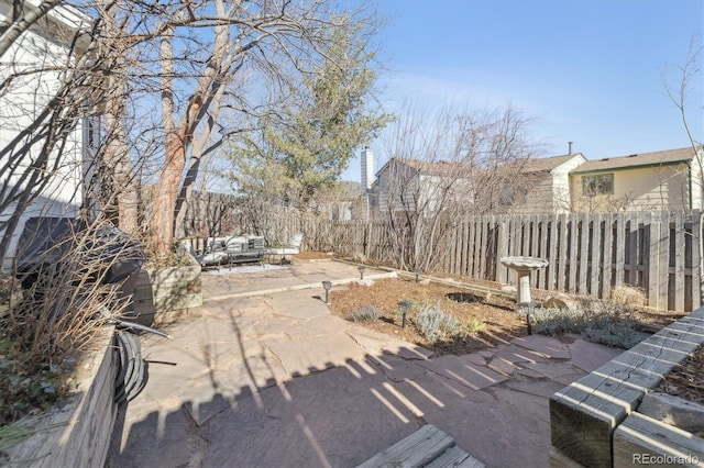 view of yard featuring an outdoor living space, a fenced backyard, and a patio area