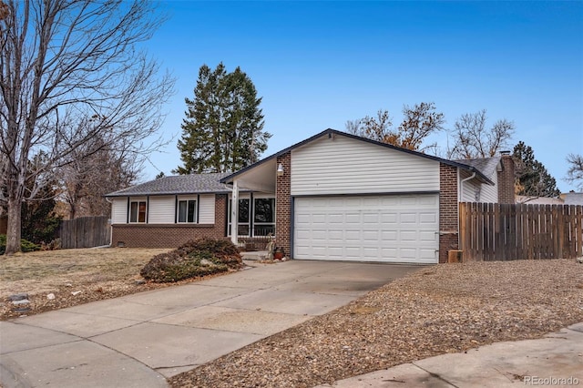 ranch-style home featuring an attached garage, fence, concrete driveway, and brick siding