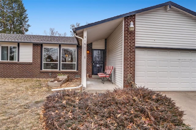 view of front of house featuring brick siding and driveway