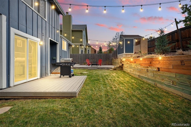 3593 S Gibralter Cir, Aurora, CO 80013 - view of yard featuring a storage unit, a wooden deck, an outbuilding, and a patio
