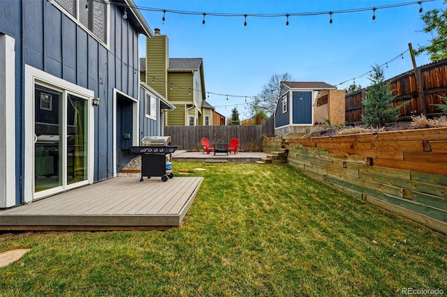 3593 S Gibralter Cir, Aurora, CO 80013 - view of yard featuring a deck, a patio area, a storage shed, and an outbuilding