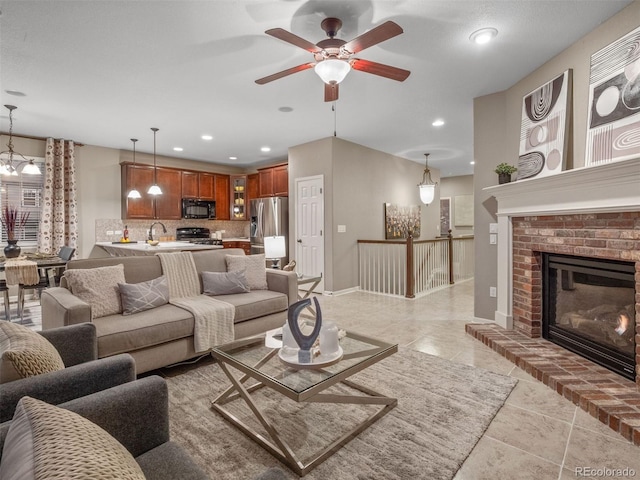 living area featuring recessed lighting, a fireplace, baseboards, and ceiling fan