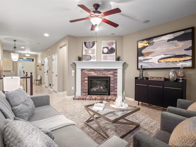 living room with visible vents, a fireplace, baseboards, and light tile patterned floors