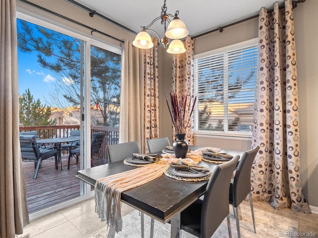 dining space featuring light tile patterned floors and a notable chandelier