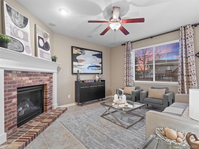 tiled living room featuring ceiling fan, a fireplace, and baseboards