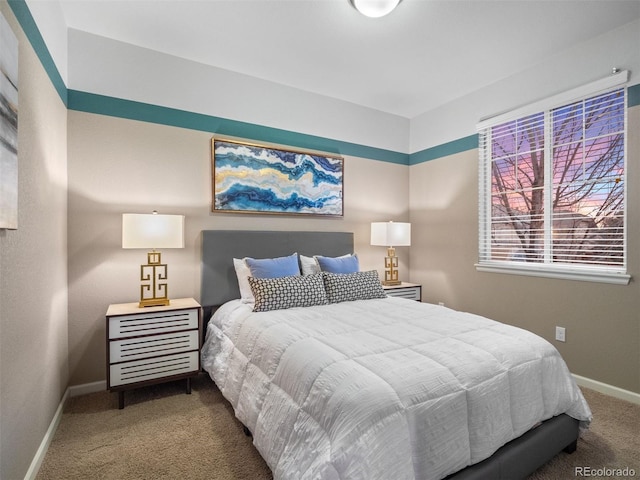 carpeted bedroom featuring baseboards