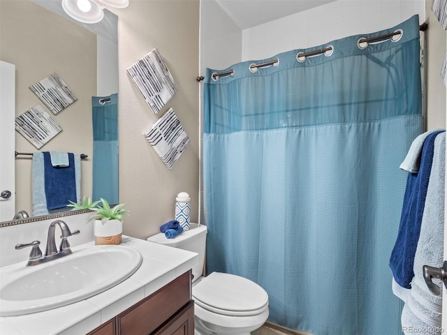 full bath featuring curtained shower, vanity, and toilet