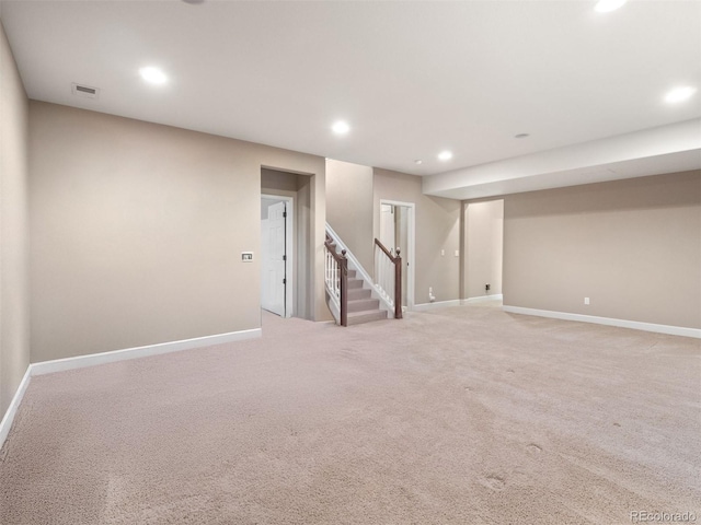 finished below grade area featuring recessed lighting, visible vents, baseboards, and stairs