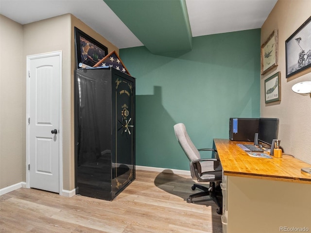 office space with baseboards and wood finished floors