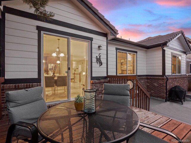 deck featuring a grill and outdoor dining area