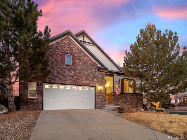 view of front of property featuring board and batten siding, concrete driveway, and brick siding