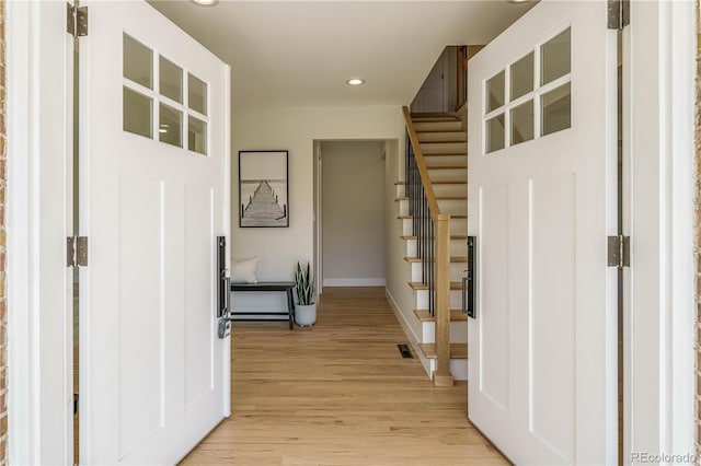 corridor with light wood-type flooring