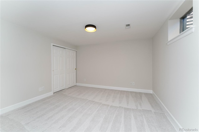 empty room featuring light colored carpet