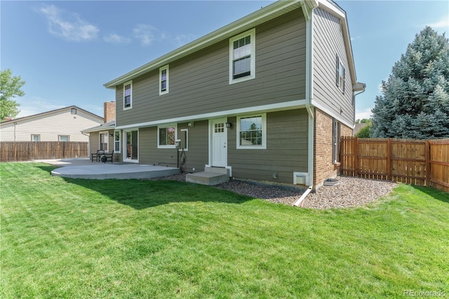 back of property featuring a yard and a patio area