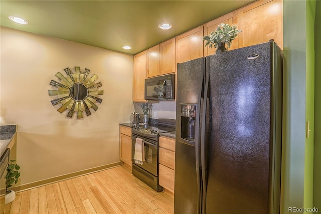 275 S Harrison St Unit 409, Denver, CO 80209 - kitchen with black appliances, light brown cabinets, dark countertops, light wood-type flooring, and recessed lighting