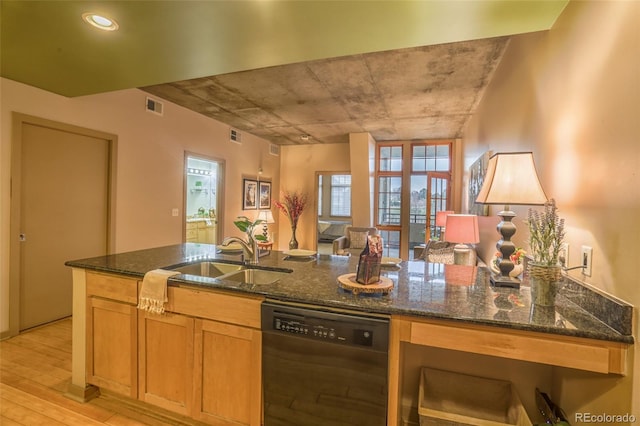 275 S Harrison St Unit 409, Denver, CO 80209 - kitchen with dishwashing machine, light wood finished floors, dark stone countertops, and open floor plan