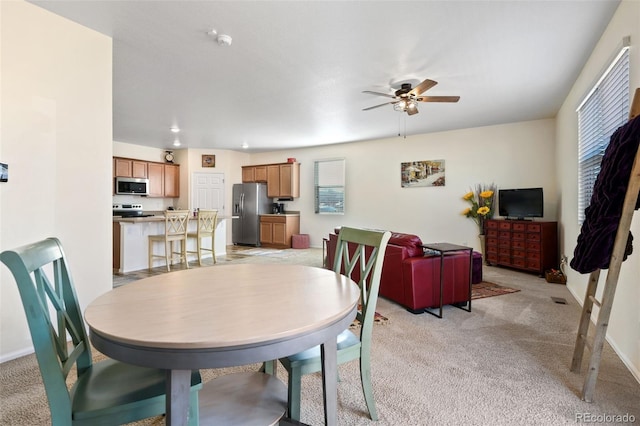 dining room with light carpet, recessed lighting, ceiling fan, and baseboards