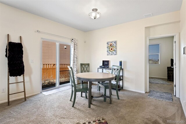 dining area with visible vents, baseboards, and carpet