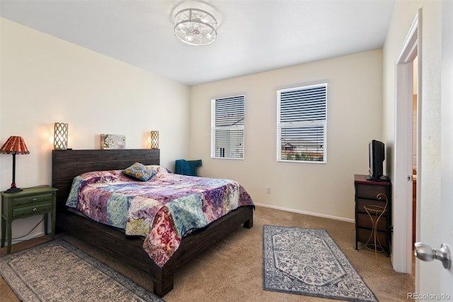 carpeted bedroom featuring baseboards