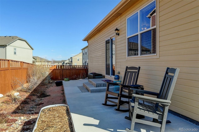 view of patio / terrace with a residential view and a fenced backyard