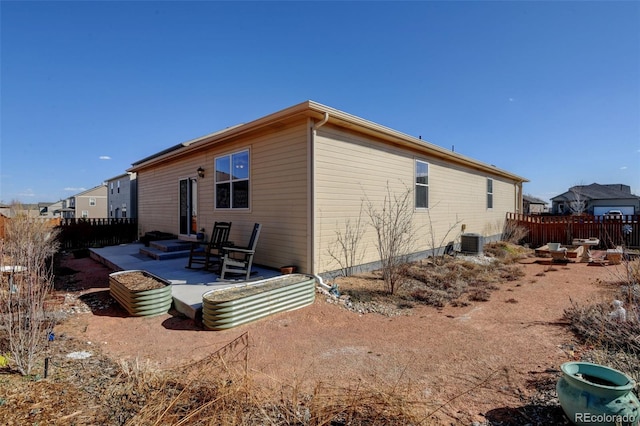 back of house featuring a patio, fence, and central AC