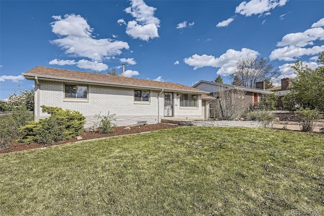 single story home with brick siding, a front lawn, and roof with shingles