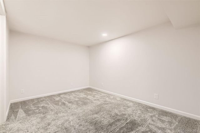 carpeted empty room featuring baseboards and recessed lighting