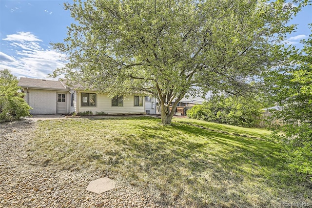 obstructed view of property with a front lawn and brick siding