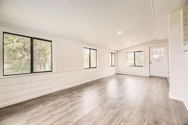 spare room with vaulted ceiling, light wood-style floors, and recessed lighting