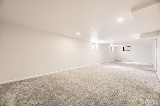 basement featuring carpet flooring, baseboards, and recessed lighting