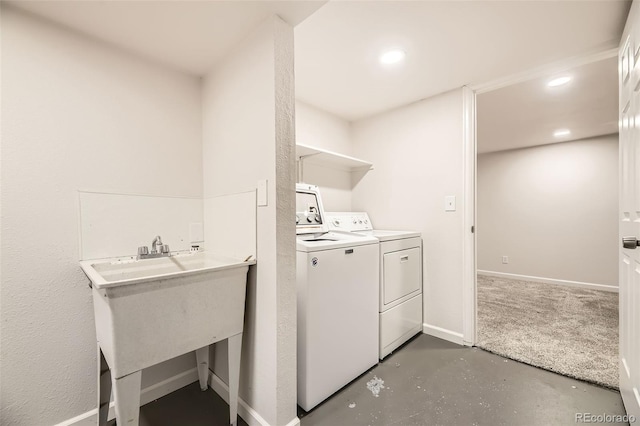 clothes washing area with washing machine and dryer, baseboards, and recessed lighting