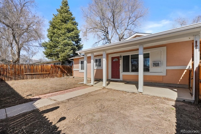 exterior space with fence and stucco siding