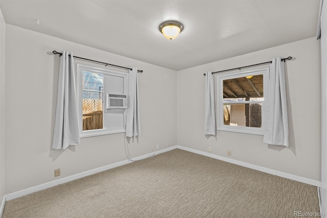 carpeted empty room with baseboards and a healthy amount of sunlight