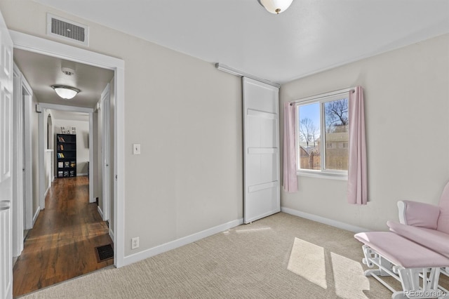 living area featuring baseboards, visible vents, and carpet flooring