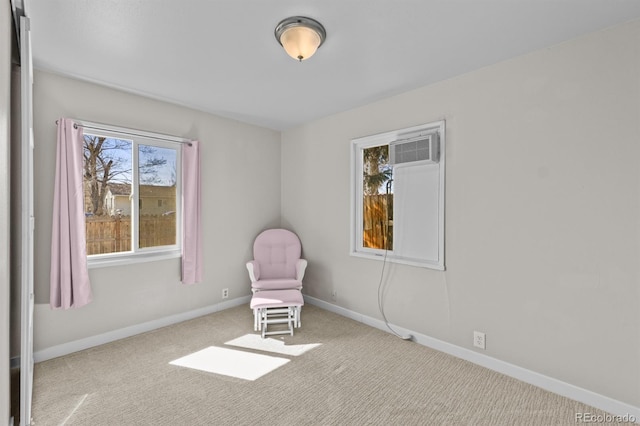 unfurnished room featuring a wall mounted AC, carpet, and baseboards