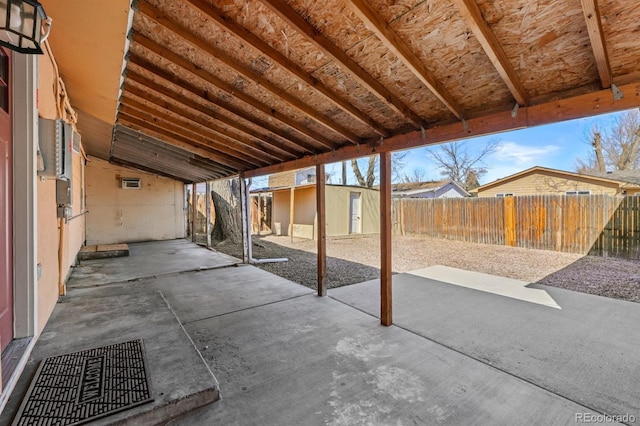 view of patio / terrace with an outbuilding and a fenced backyard