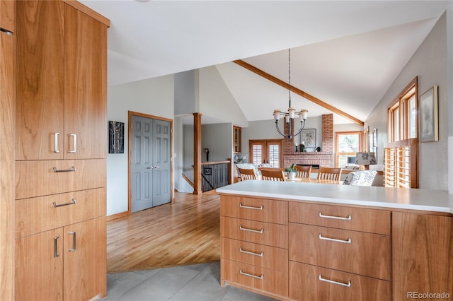 kitchen with a peninsula, vaulted ceiling, and light countertops