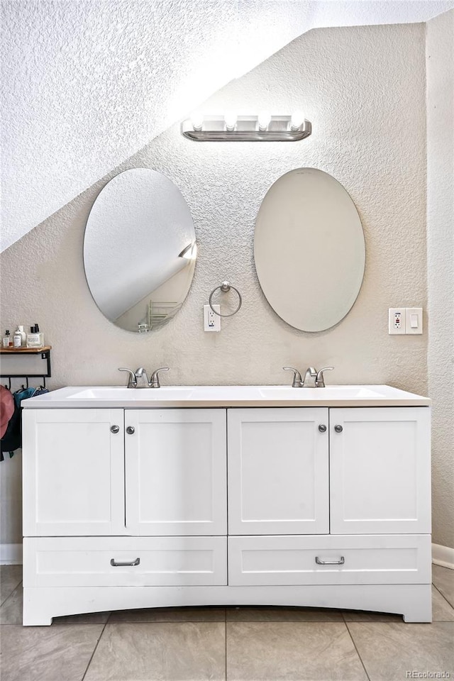 bathroom featuring tile patterned flooring and vanity