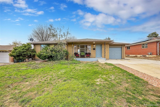 single story home with a front lawn, covered porch, and a garage