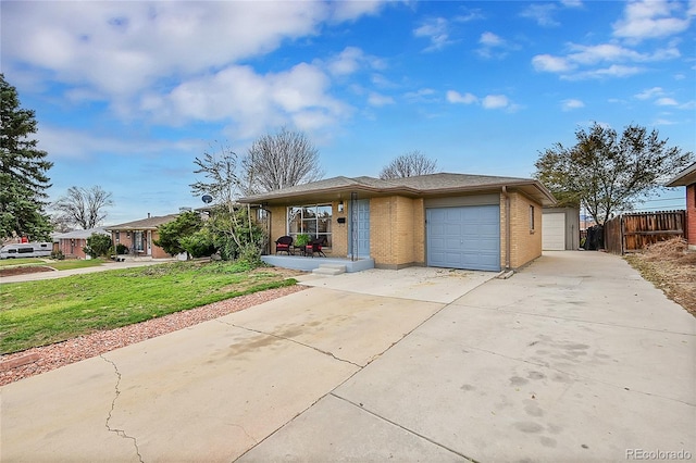 ranch-style home with a front lawn and a garage