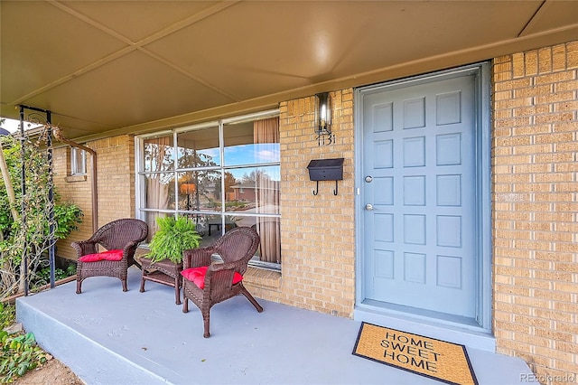 view of exterior entry featuring covered porch