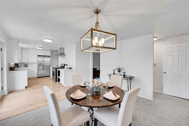 dining space featuring a chandelier and light hardwood / wood-style floors