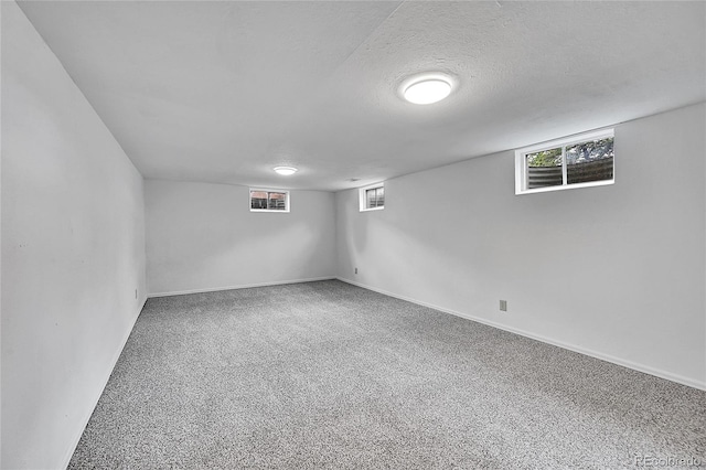 basement with carpet and a textured ceiling