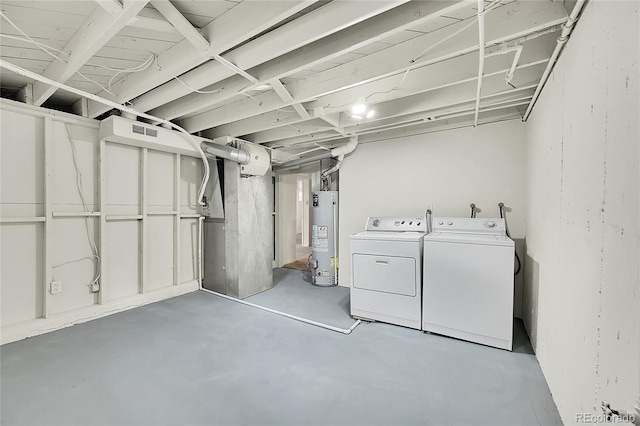 basement featuring washer and dryer and gas water heater