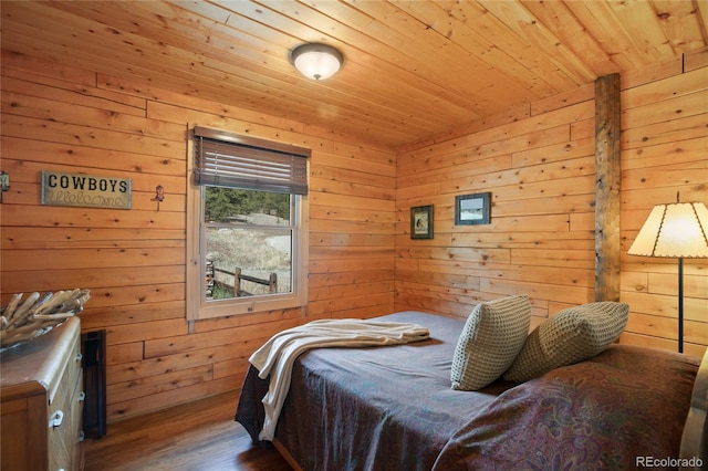 bedroom featuring wood finished floors, wooden walls, and wood ceiling